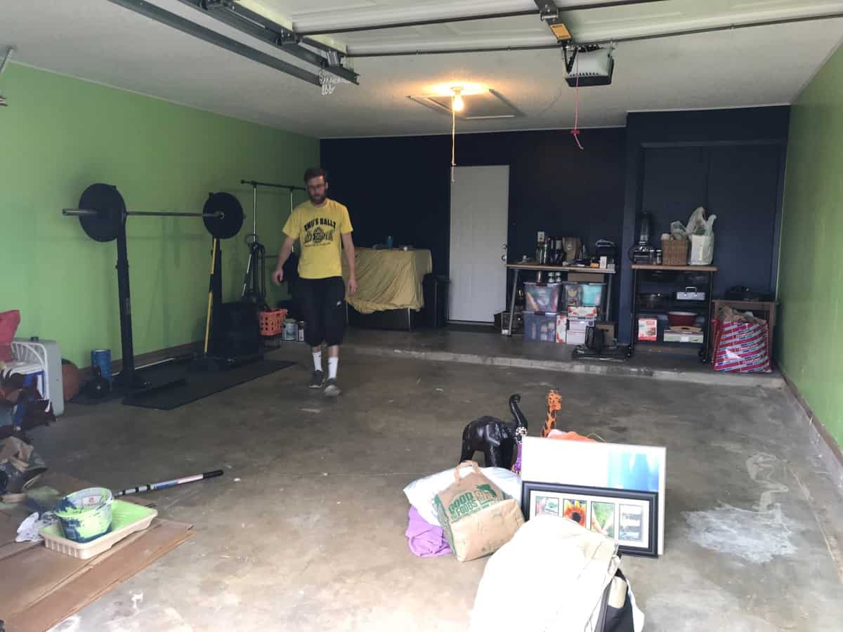 Messy garage with newly painted walls - one light green and one dark blue