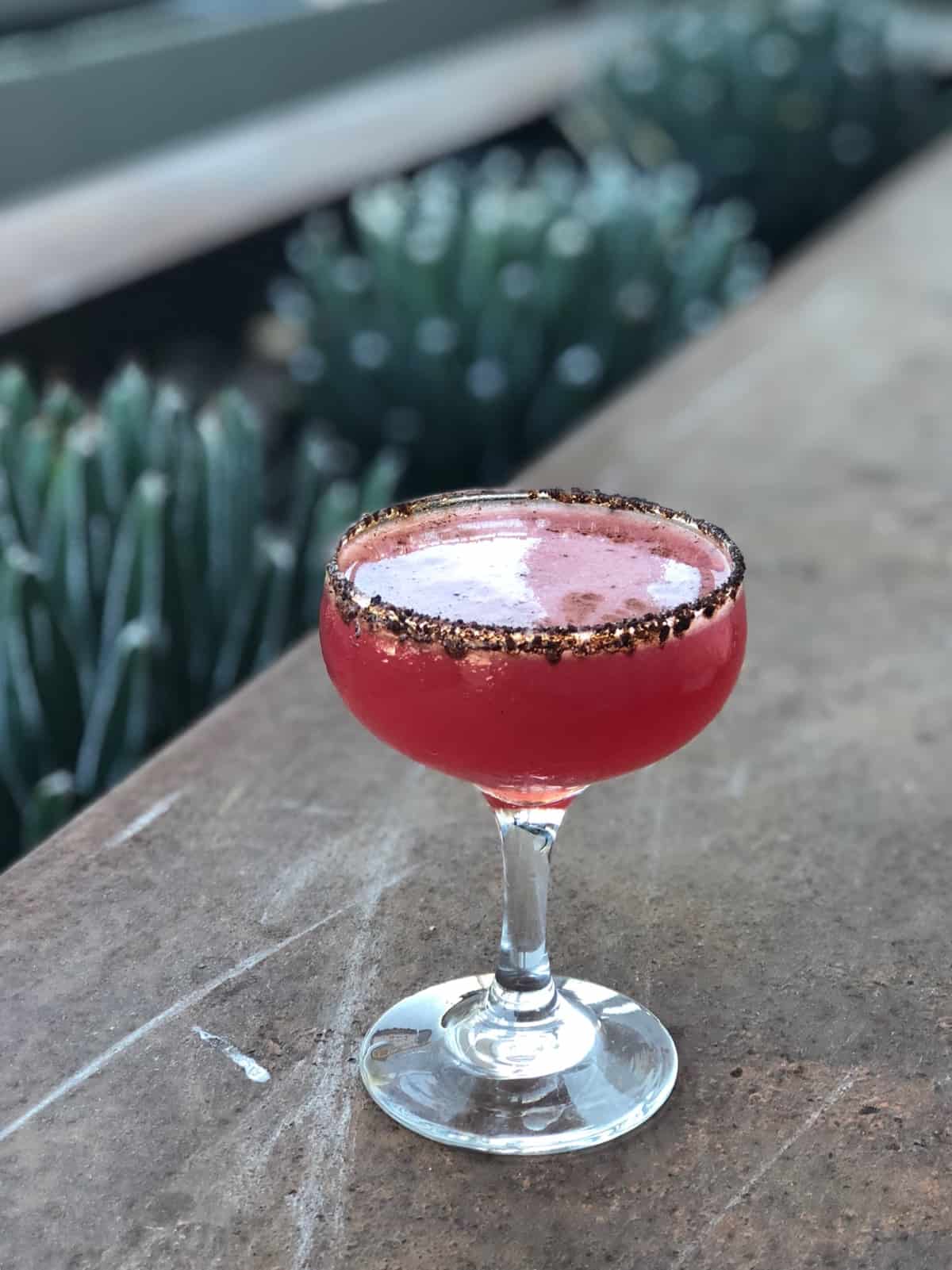 Pomegranate tequila drink with a chili rim