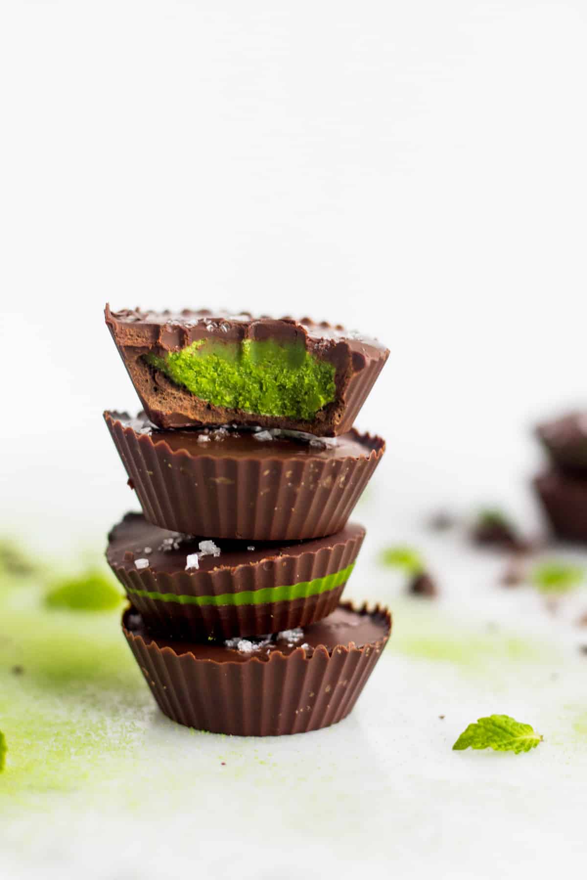 A stack of 4 Collagen Mint Matcha Coconut Butter Cups with 2 in the background