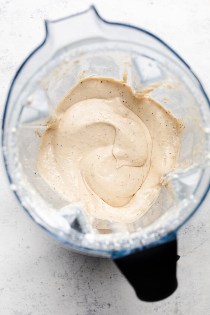Overhead shot of creamy lemon garlic sauce in a blender.