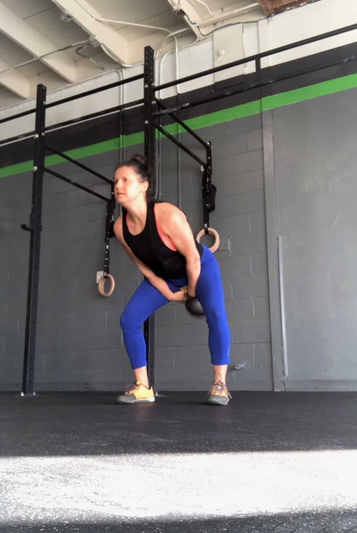 Girl doing a heavy kettleswing