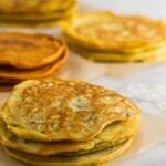 4 different kinds of paleo proteins on parchment paper on a white marble counter
