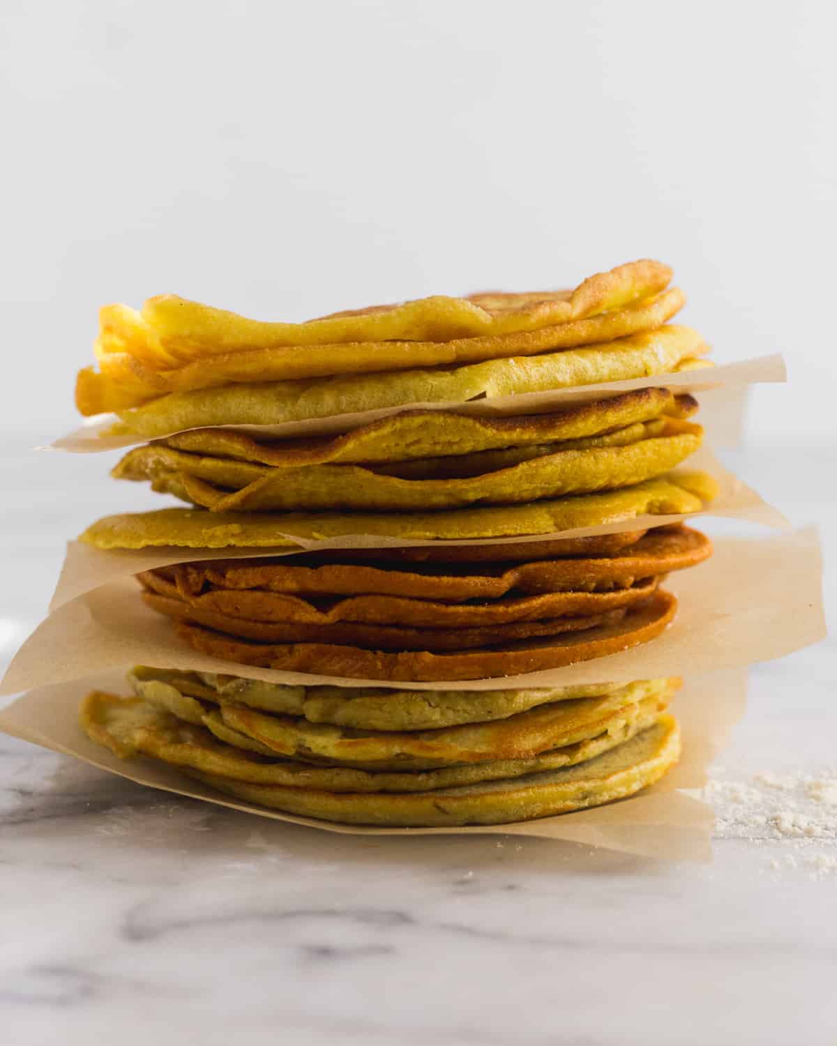 4 different kinds of paleo protein tortillas all stacked on top of each other