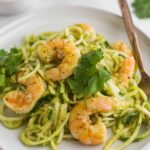 Large plate filled with Whole30 Tomatillo Salsa Shrimp Zucchini Noodles with a fork in them