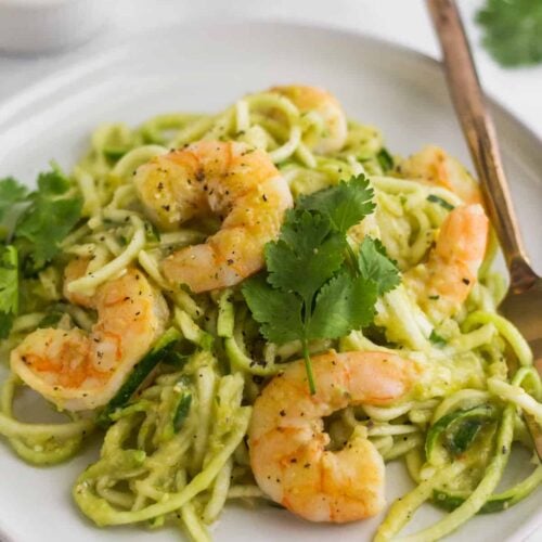 Large plate filled with Whole30 Tomatillo Salsa Shrimp Zucchini Noodles with a fork in them