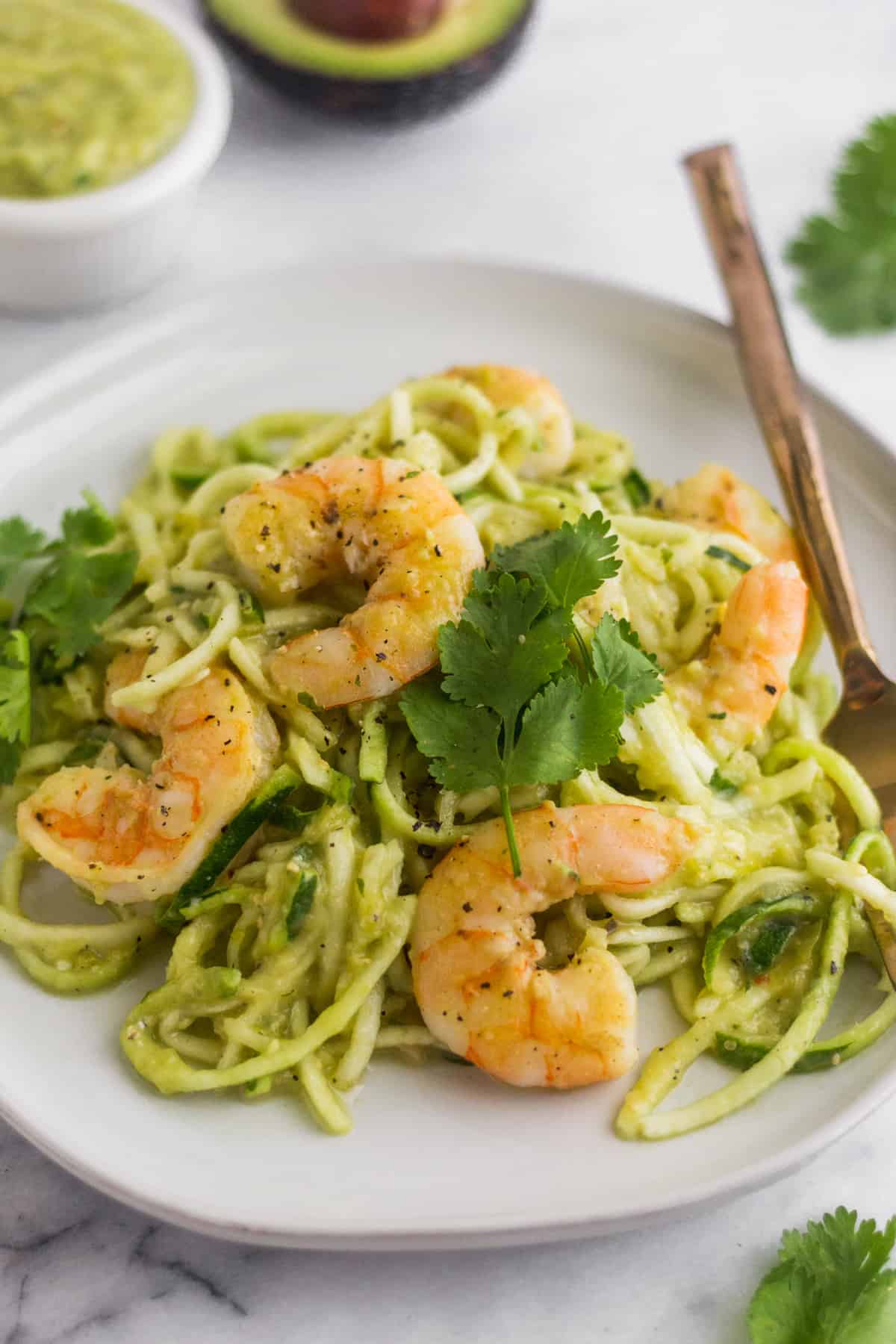 Large plate filled with Whole30 Tomatillo Salsa Shrimp Zucchini Noodles with a fork in them