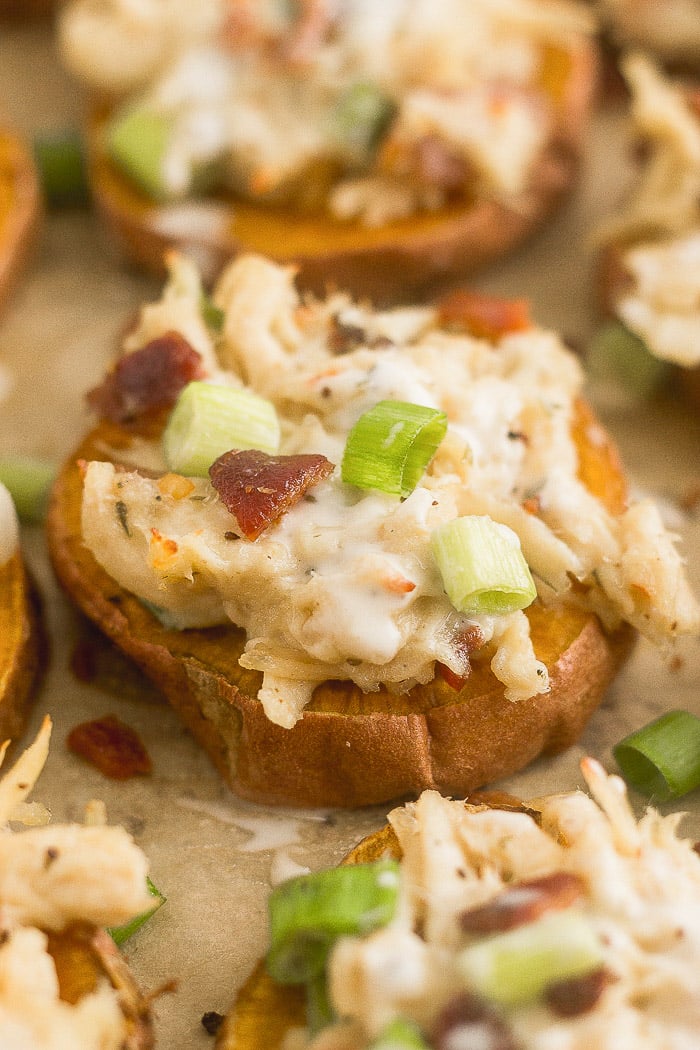 Individual chicken bacon ranch pizza on a baking sheet.