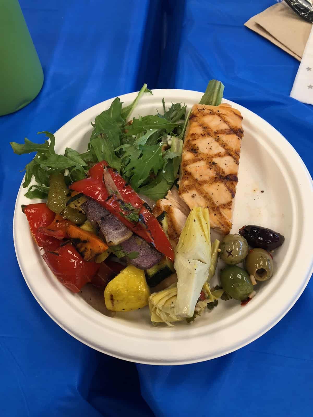 Catered lunch of salad, roasted veggies, salmon, and olives
