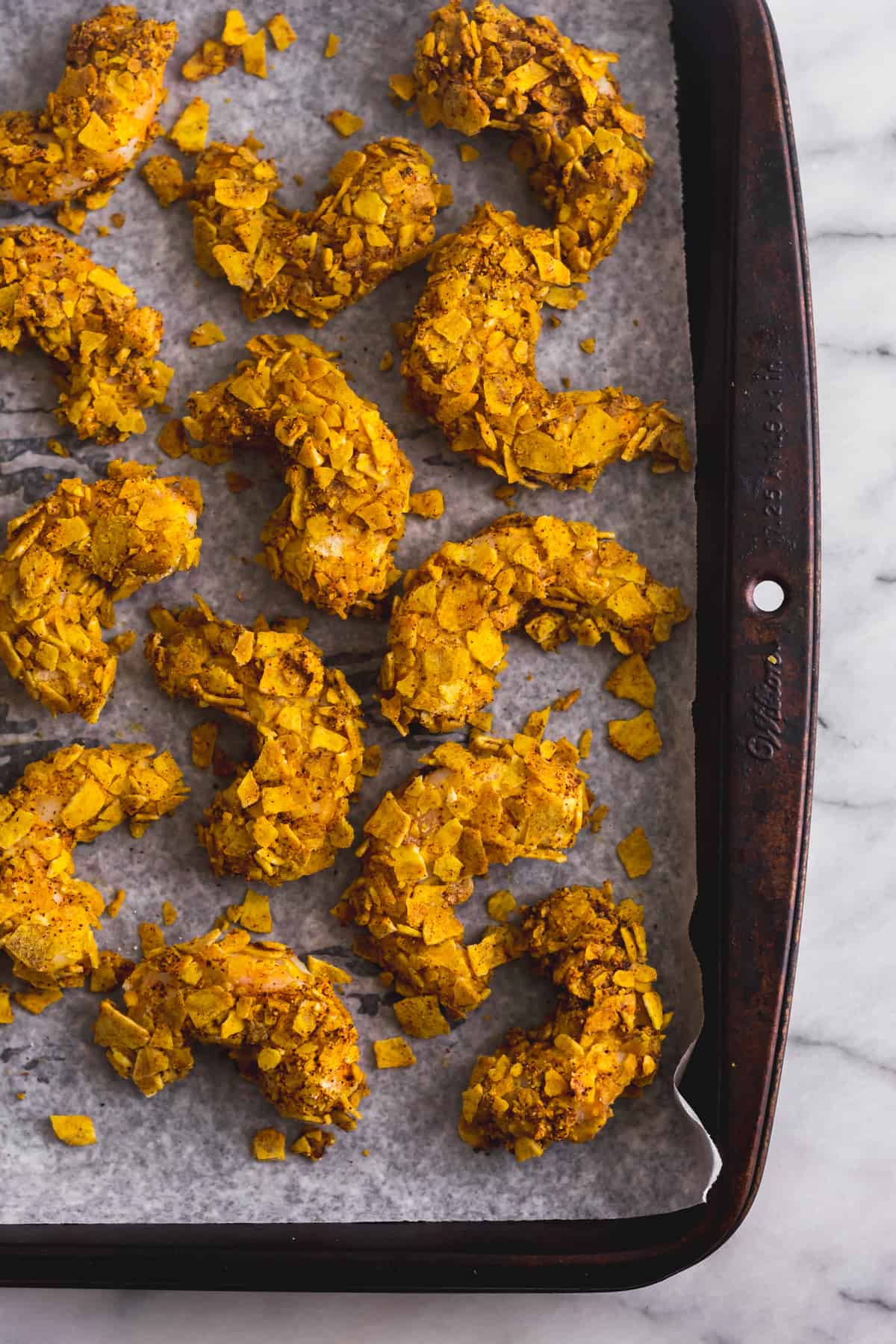 Baking sheet full of plantain crusted shrimp