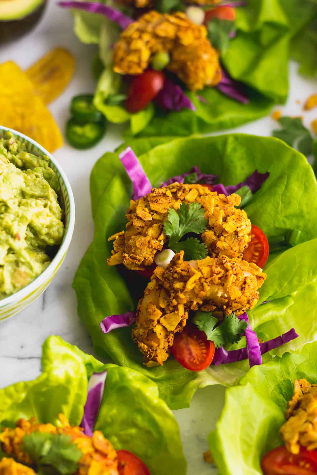 Close up of a Paleo Plantain Crusted Crispy Shrimp Tacos in a lettuce wrap