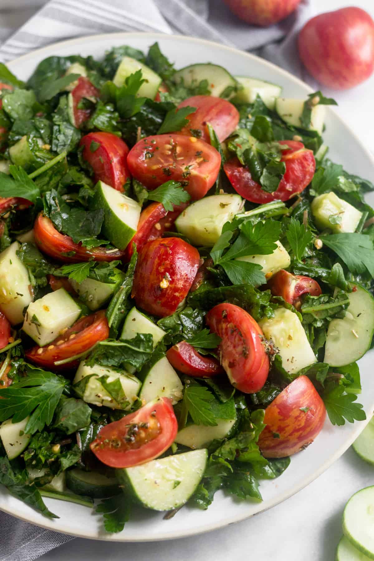 Large white plate of Chopped Tomato Cucumber Kale Salad