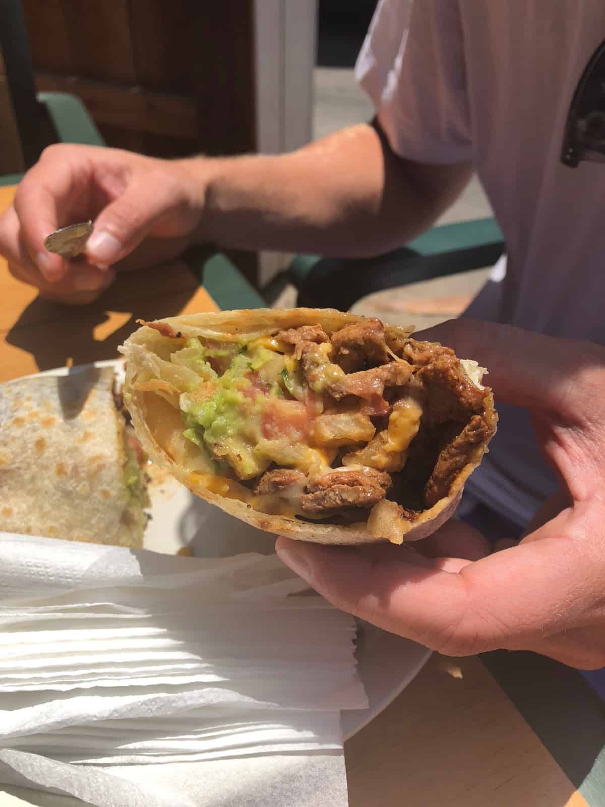 California burrito - burrito stuffed with carne asada, french fries, cheese, guacamole, tomatoes 