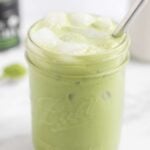 Large glass filled with a paleo iced matcha latte with a metal straw in it