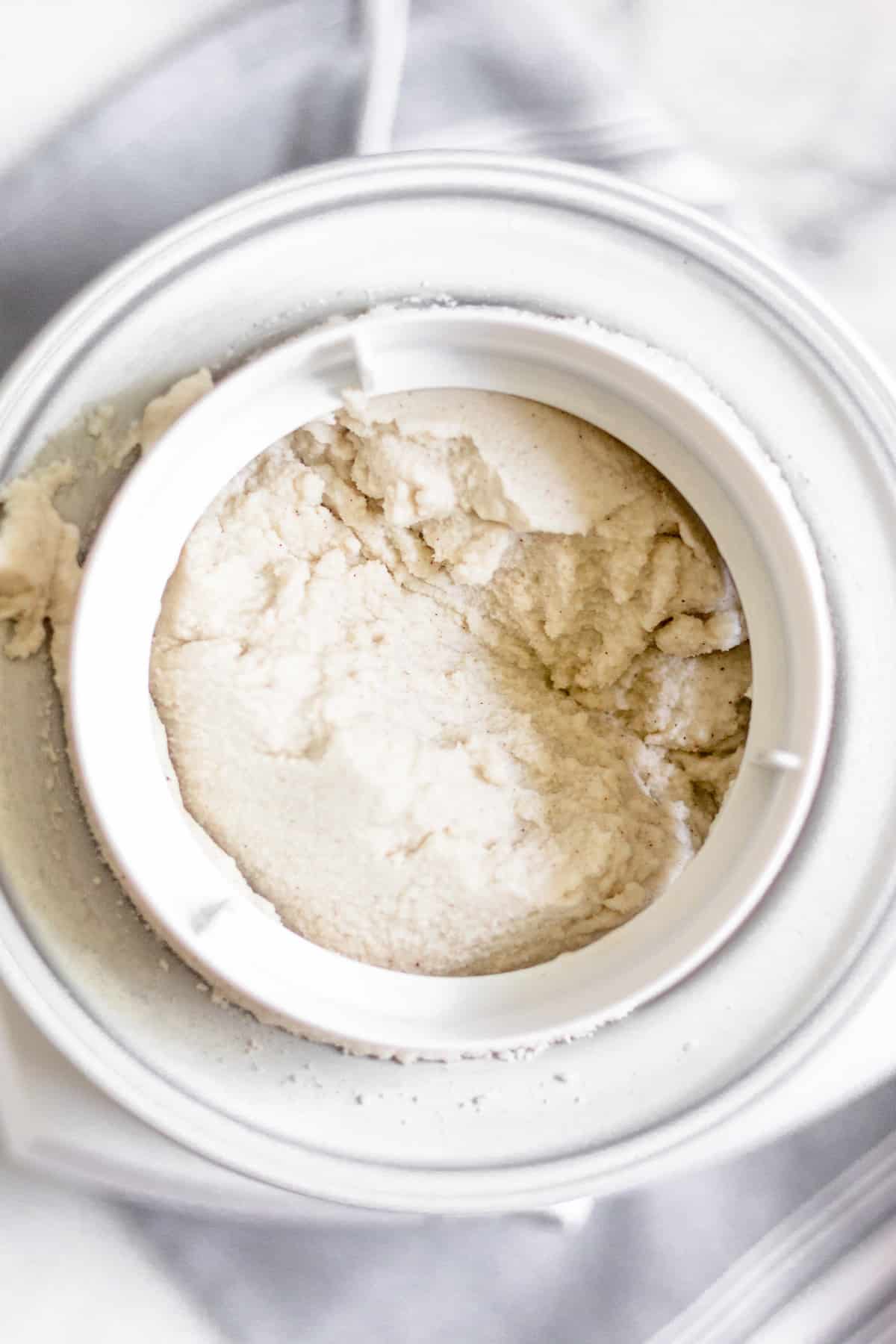 Ice cream maker filled with dairy free vanilla ice cream made from coconut milk