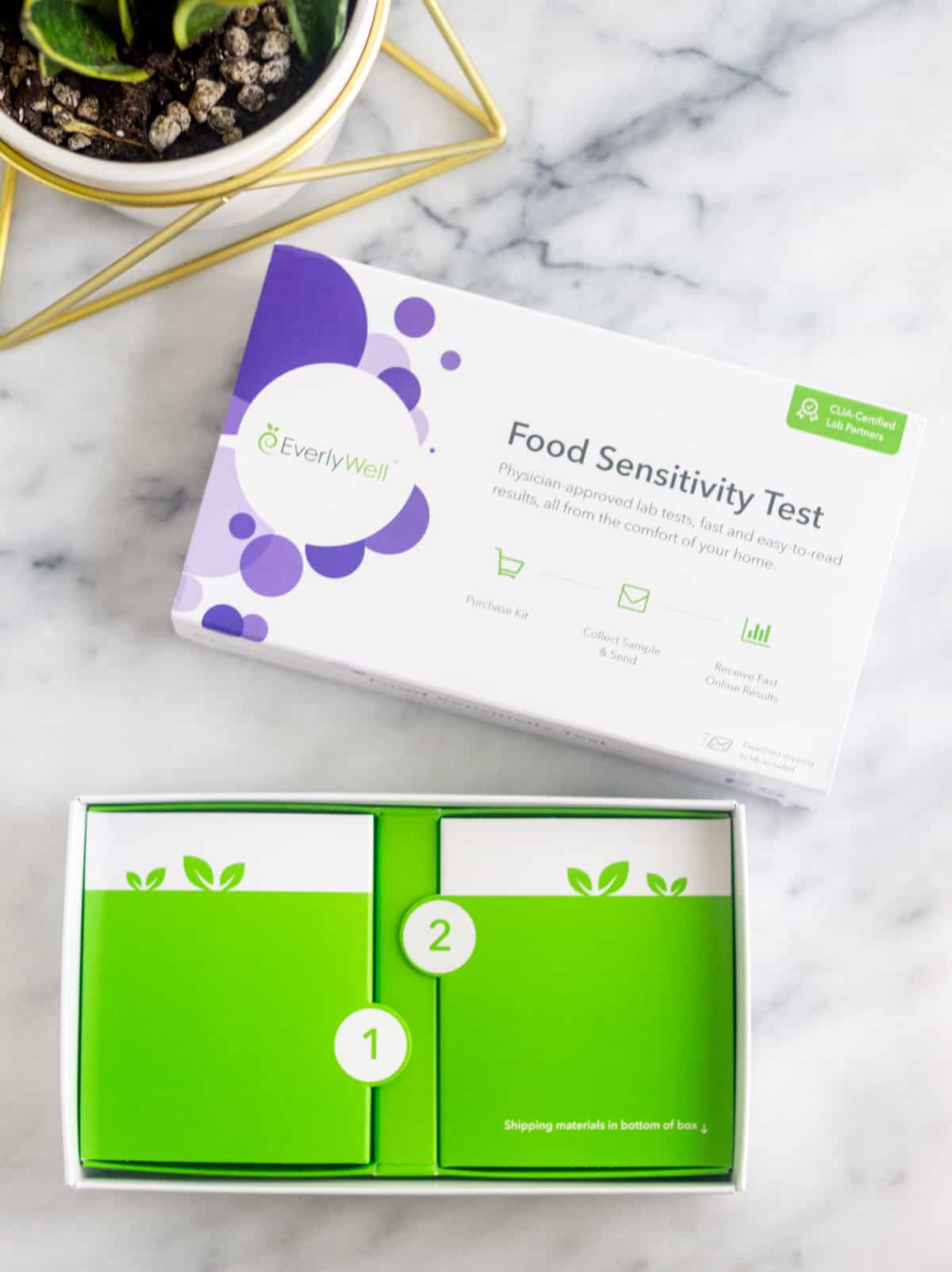 EverlyWell Food Sensitivity test box open on a white counter with the first steps in the box