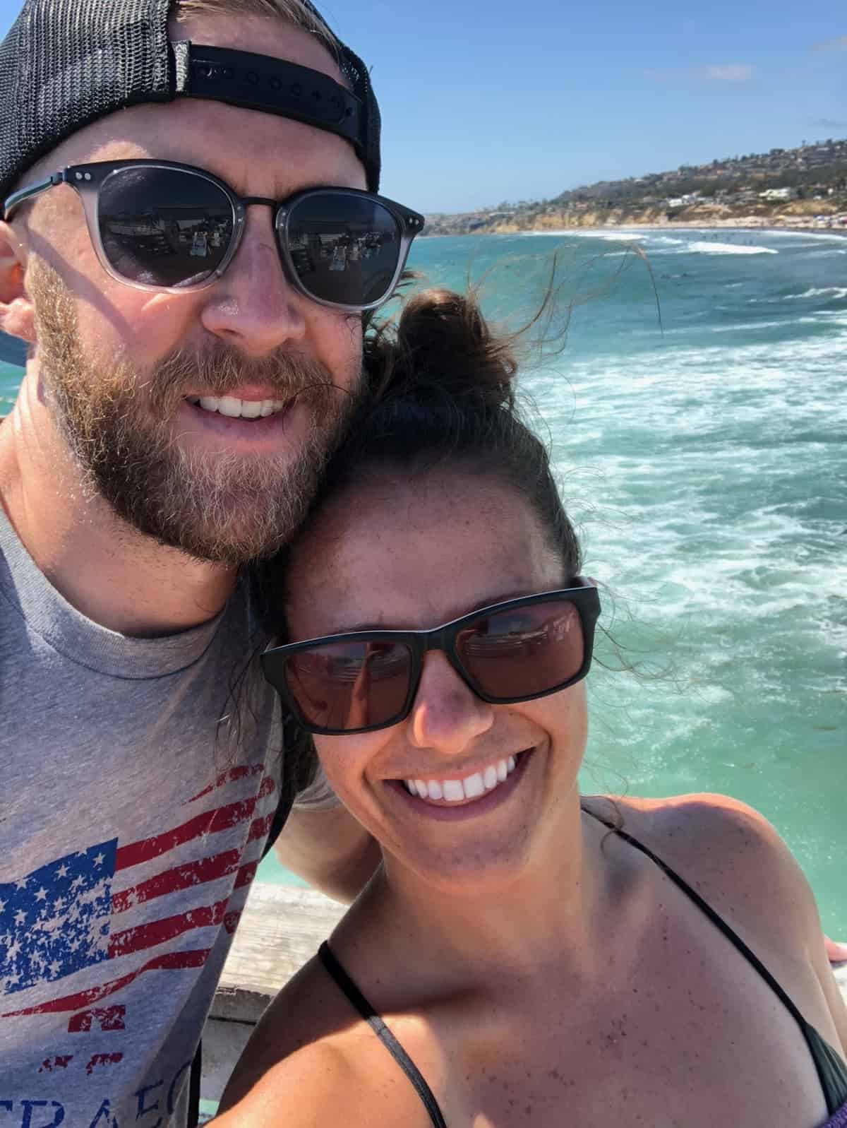 Guy and a girl taking a selfing with the Pacific Ocean behind them