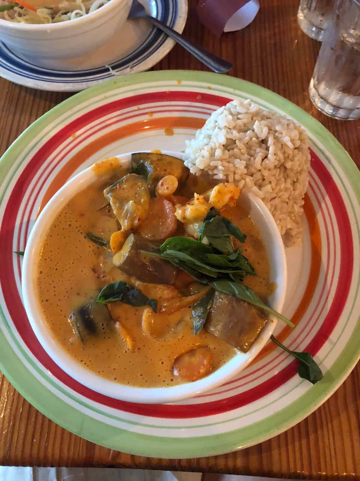 Red curry with vegetables and rice on the side
