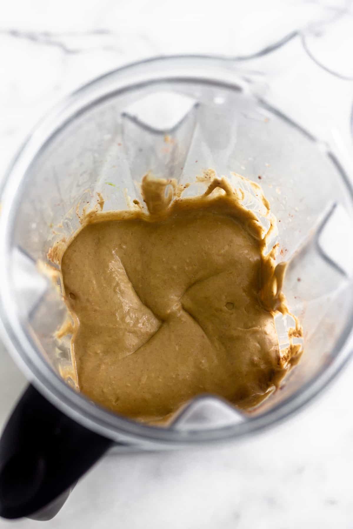 Blender filled with a rich and creamy dairy free peanut butter frosty