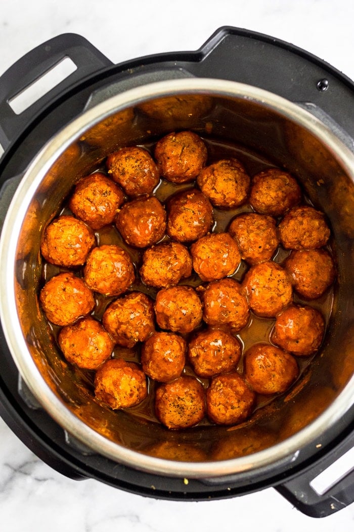 Instant Pot filled with Whole30 chicken meatballs covered in BBQ sauce.