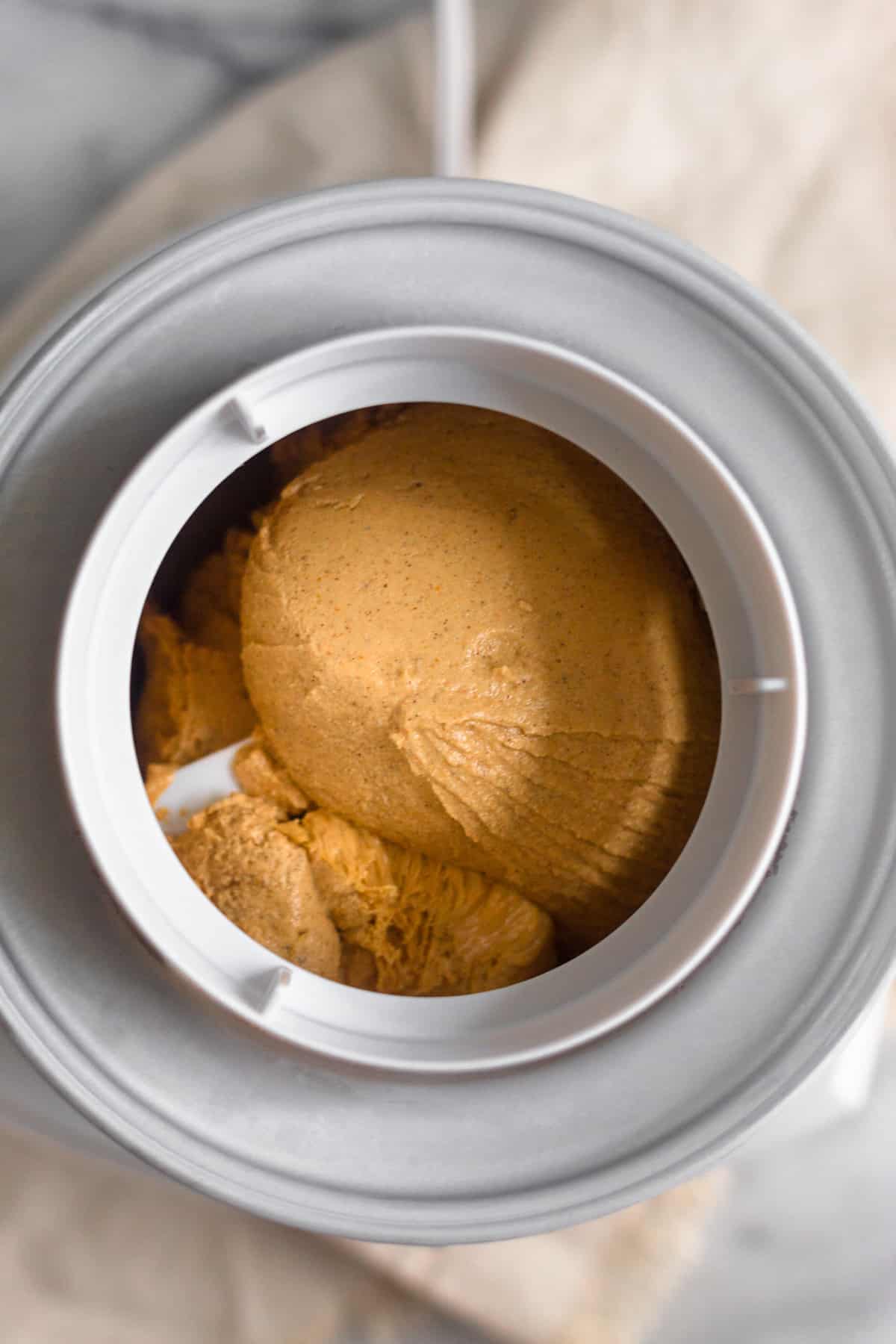 Ice cream maker filled with paleo pumpkin ice cream