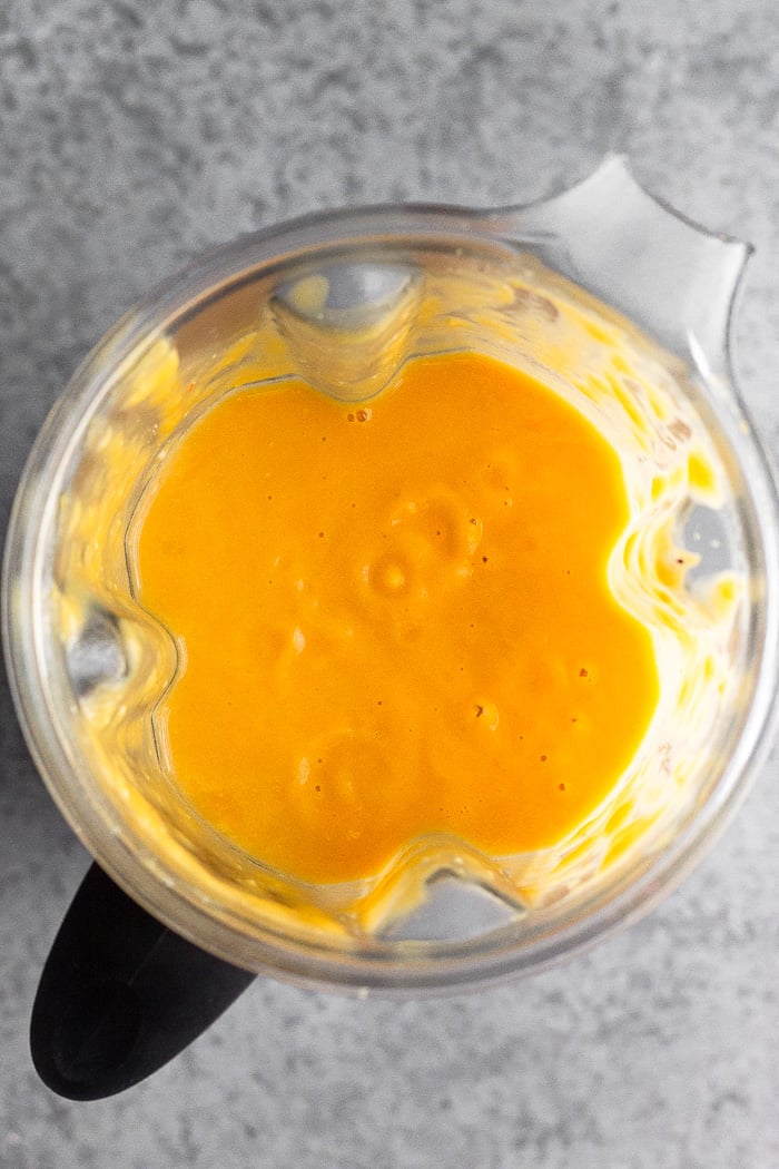 Blender filled with creamy pumpkin soup.