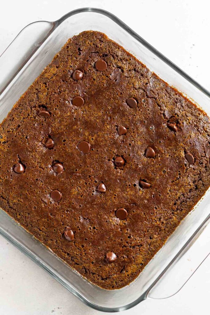 Overhead shot of gingerbread blondies in a square baking dish before they are cut.