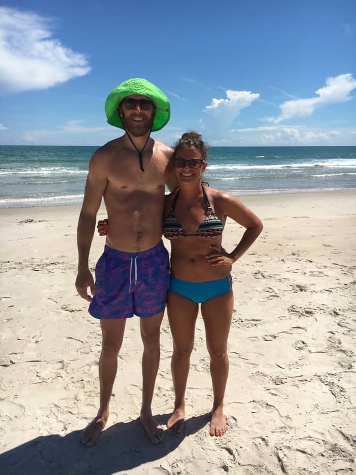 Boyfriend and girlfriend in their baiting suits on the beach