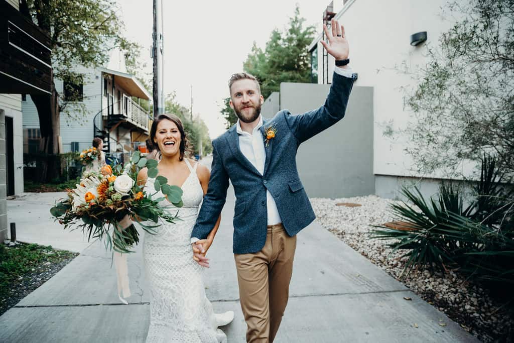 Bride in Groom after they got married cheering because they are so happy.