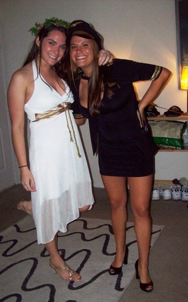 Two girls in halloween costumes - ones is a goddess and one is a flight attendant