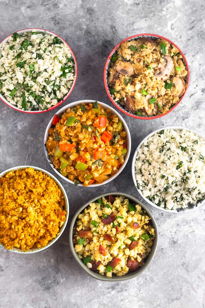 Overhead shot of 6 different bowls filled with 6 different paleo and Whole30 cauliflower rice recipes.