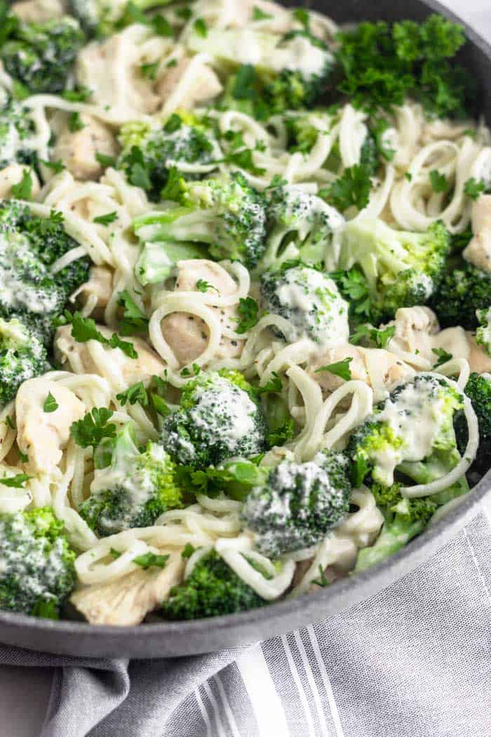 Close up a skillet filled with dairy free Whole30 Chicken and Broccoli Alfredo.