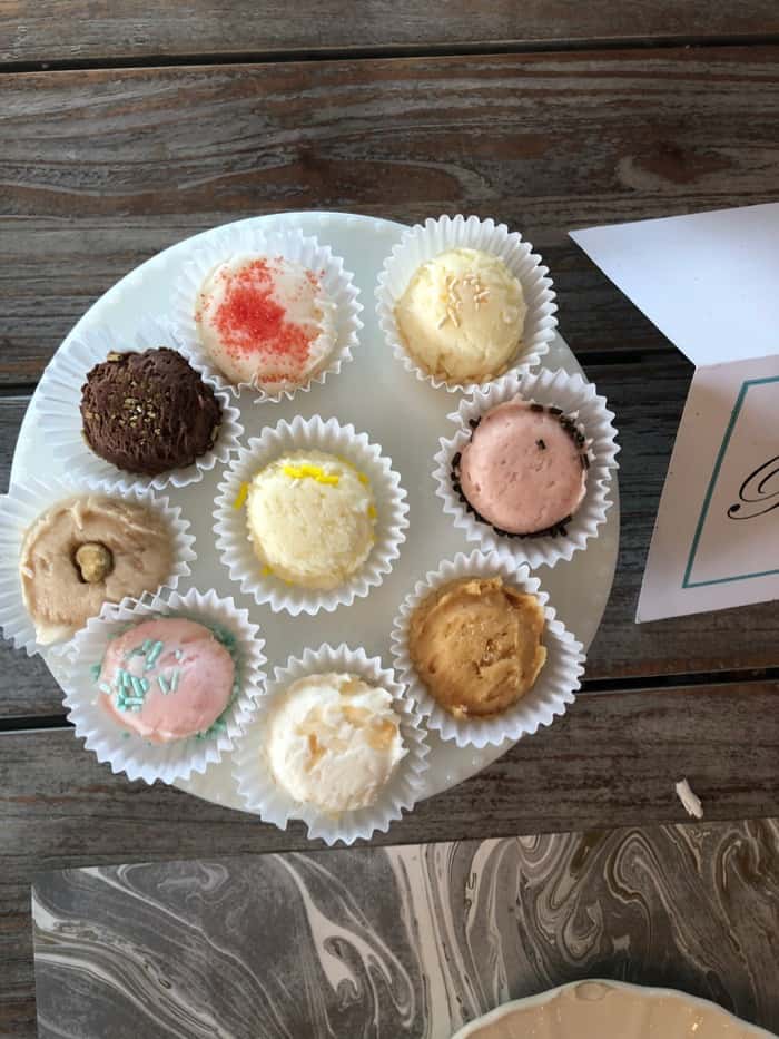 Cake stand filled with 9 different buttercream icings.