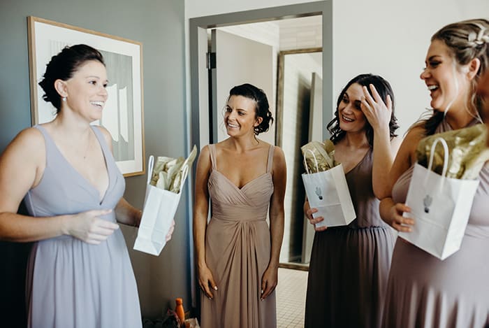 A group of bridesmaids getting laughing and ready for a wedding.