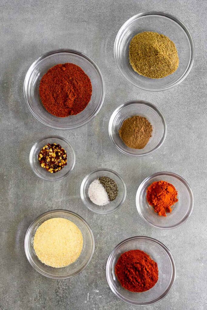 Overhead shot of a bunch of different bowls of spices.