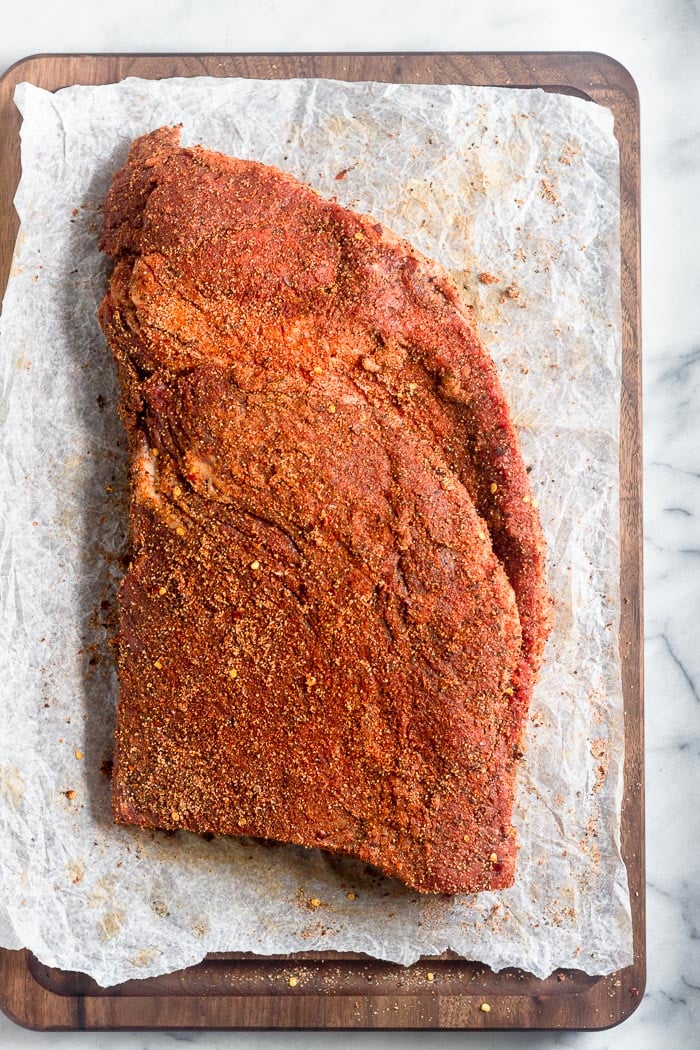 Large brisket with dry rub all over it.
