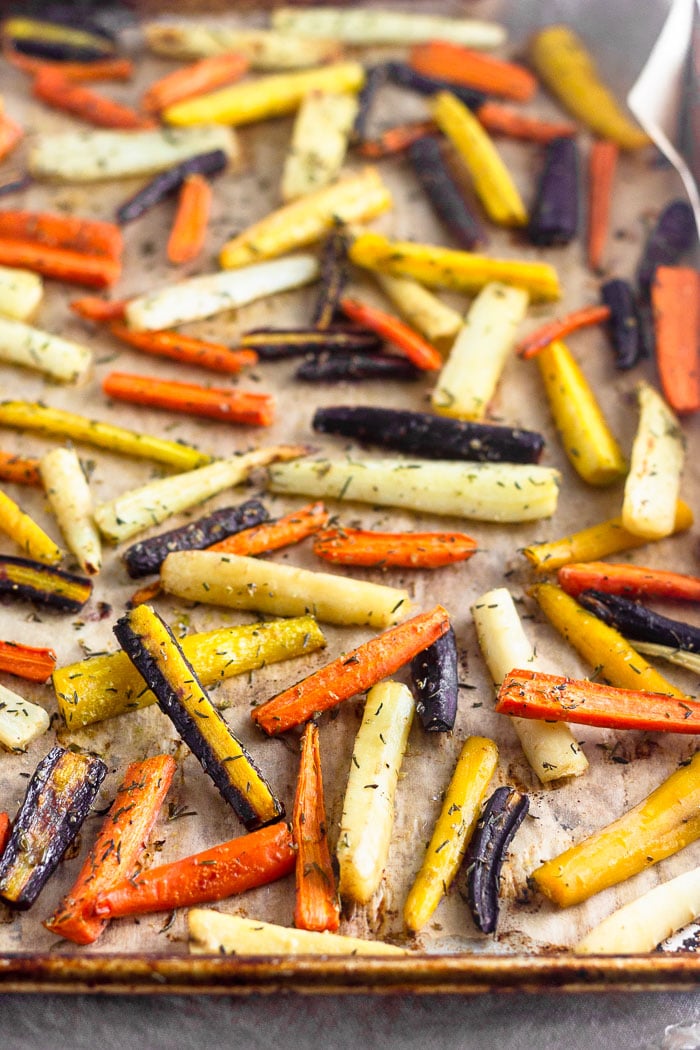 Large baking sheet filled with rainbow roasted carrots.