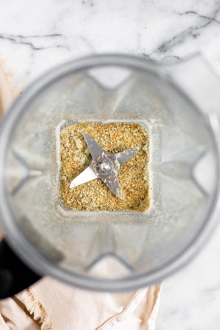 Blender filled with freshly ground flax and pumpkin seeds for seed cycling.