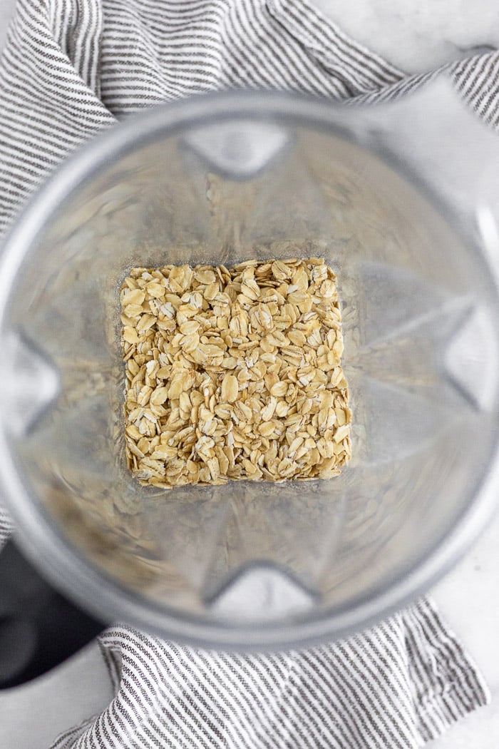 A blender with filled with rolled oats.