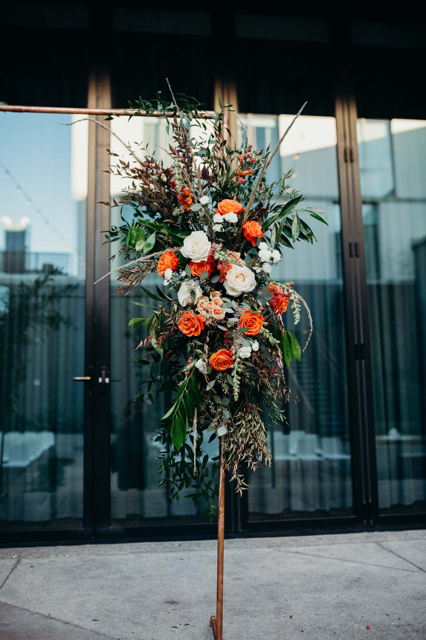 Flowers on a brass arch in a wedding.