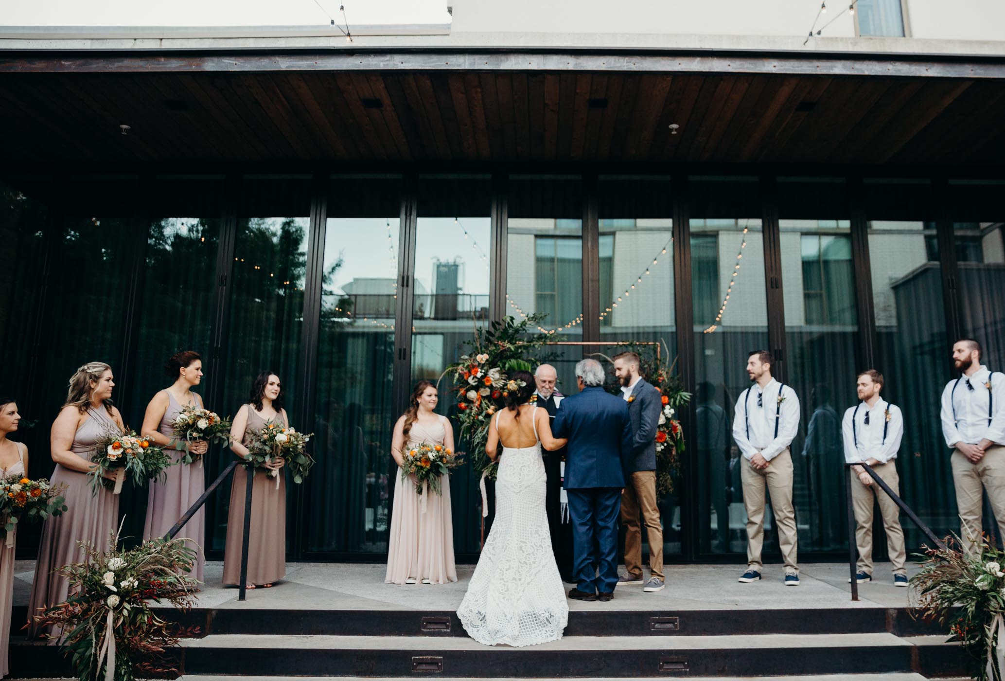 Dad giving off his daughter to her soon to her husband on her wedding day.