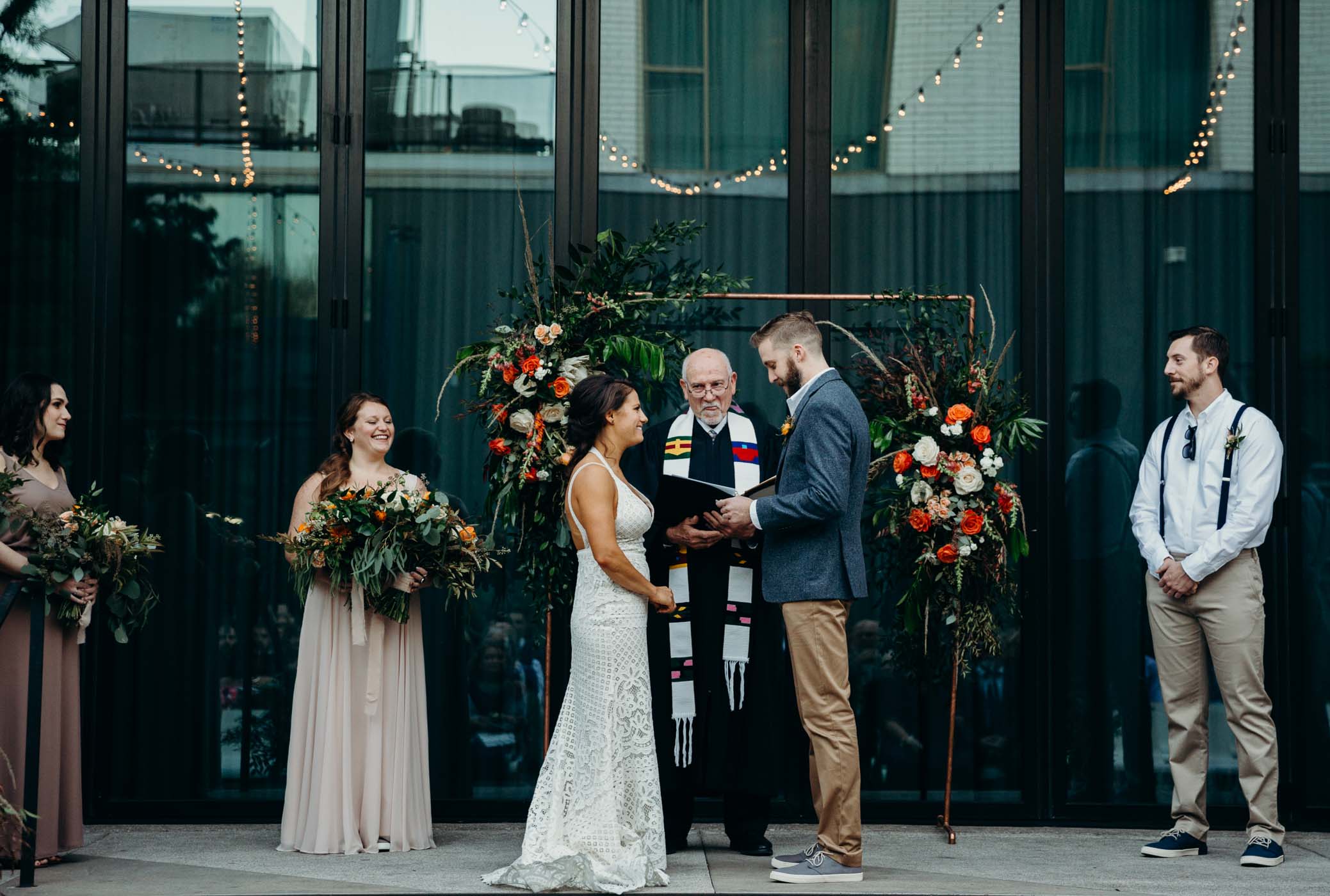 Bridge and groom at the alter and the groom is reading his vows to his soon to be wife. 