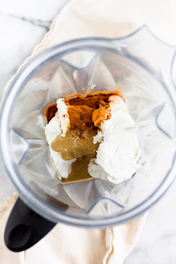 Blender full of vanilla ice cream, almond milk, tahini, cinnamon, and vanilla extract.