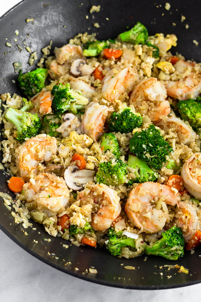 Close of a large wok with paleo shrimp fried rice in it.