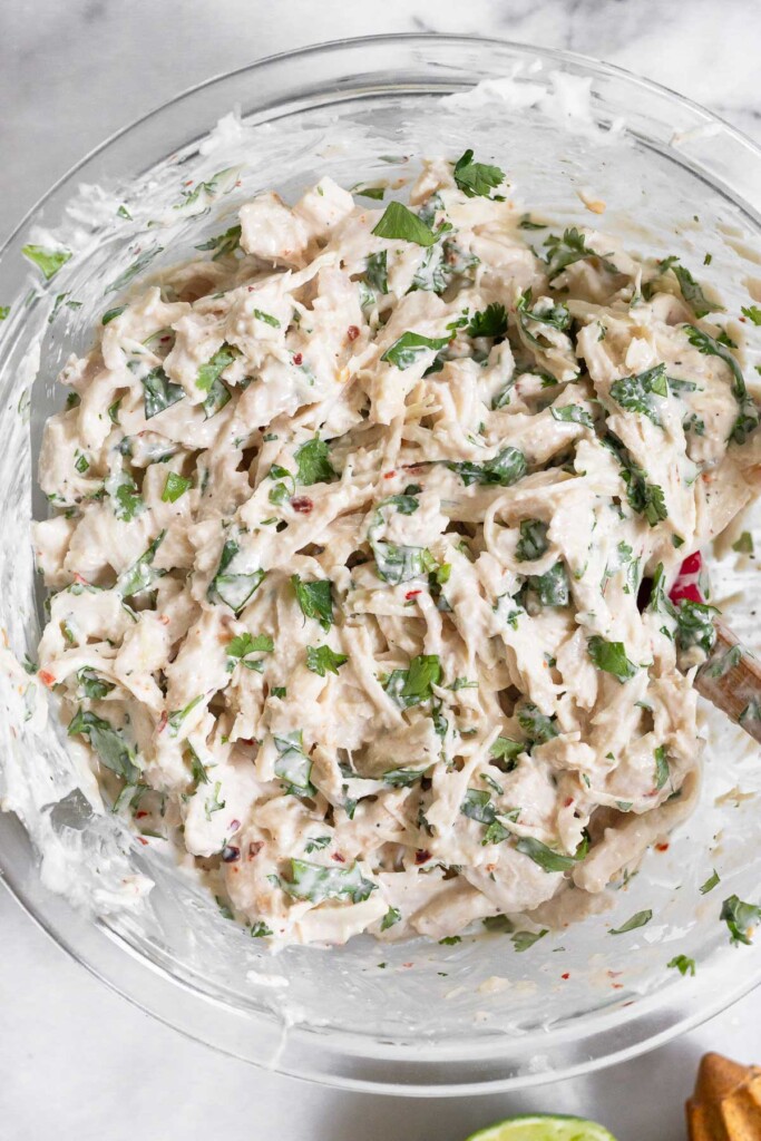 Chicken salad with greek yogurt in a large glass bowl.