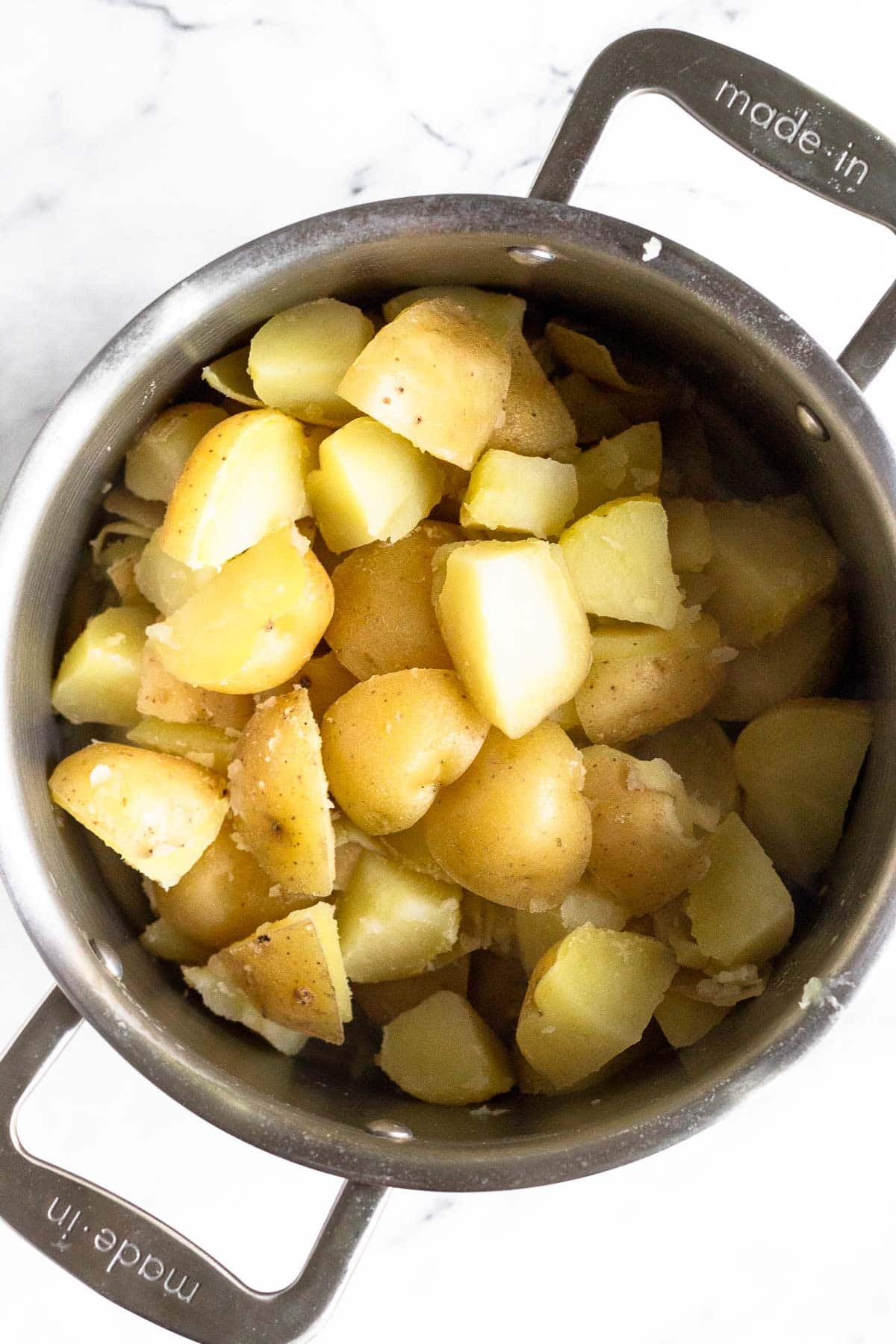 Cooked chopped Yukon gold potatoes in a large pot.
