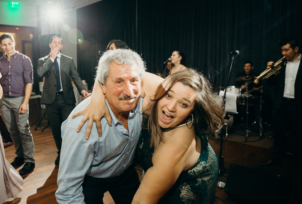 Older guy and a younger girl dancing at wedding.
