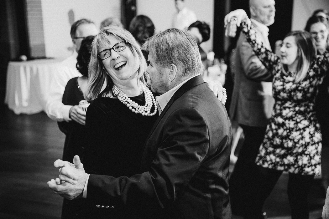 Older man and woman dancing with each other at a wedding.