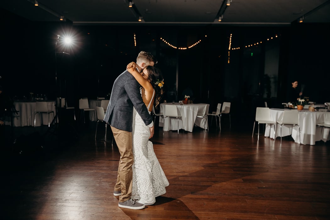 Bride and groom embracing doing their last dance at their wedding.