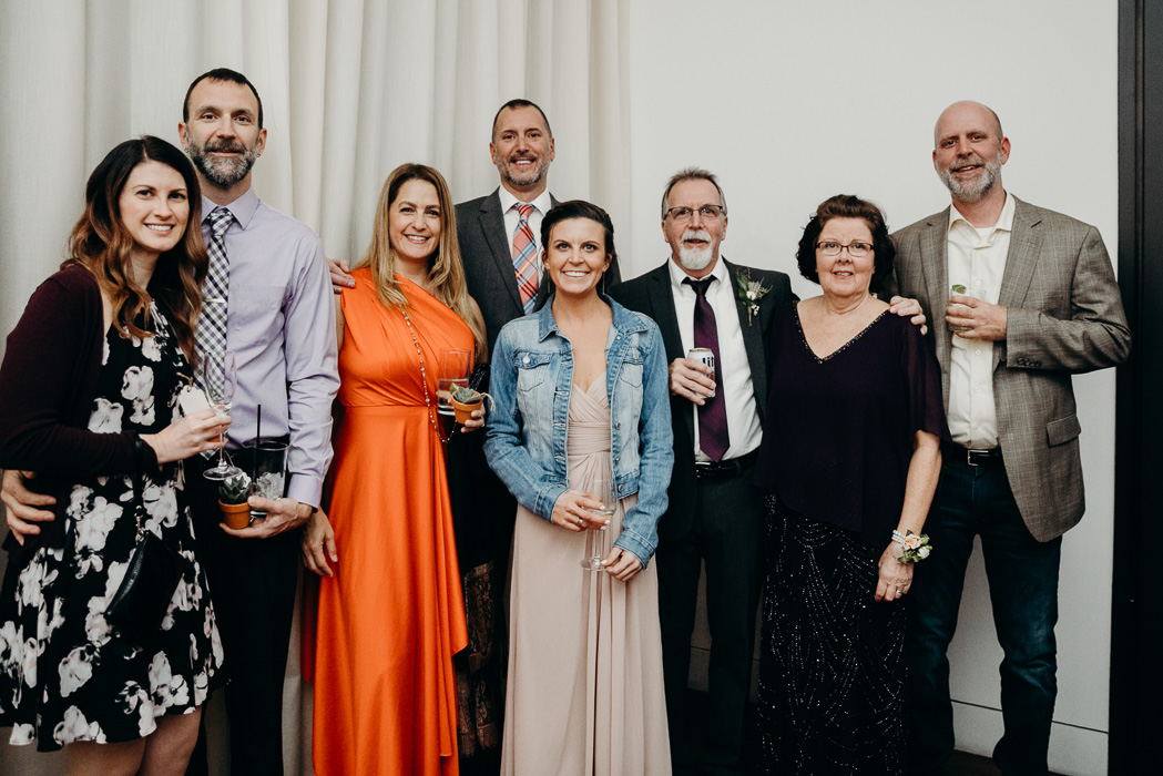 Large group of people with posing for a picture at a wedding