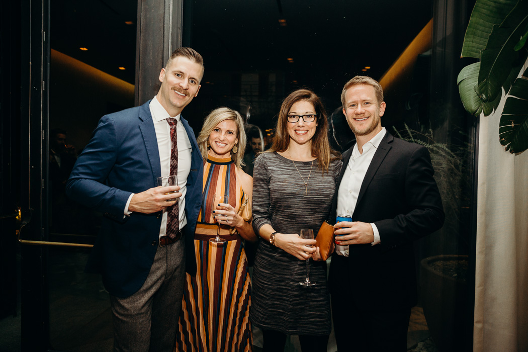 Two couples dressed up at a wedding.